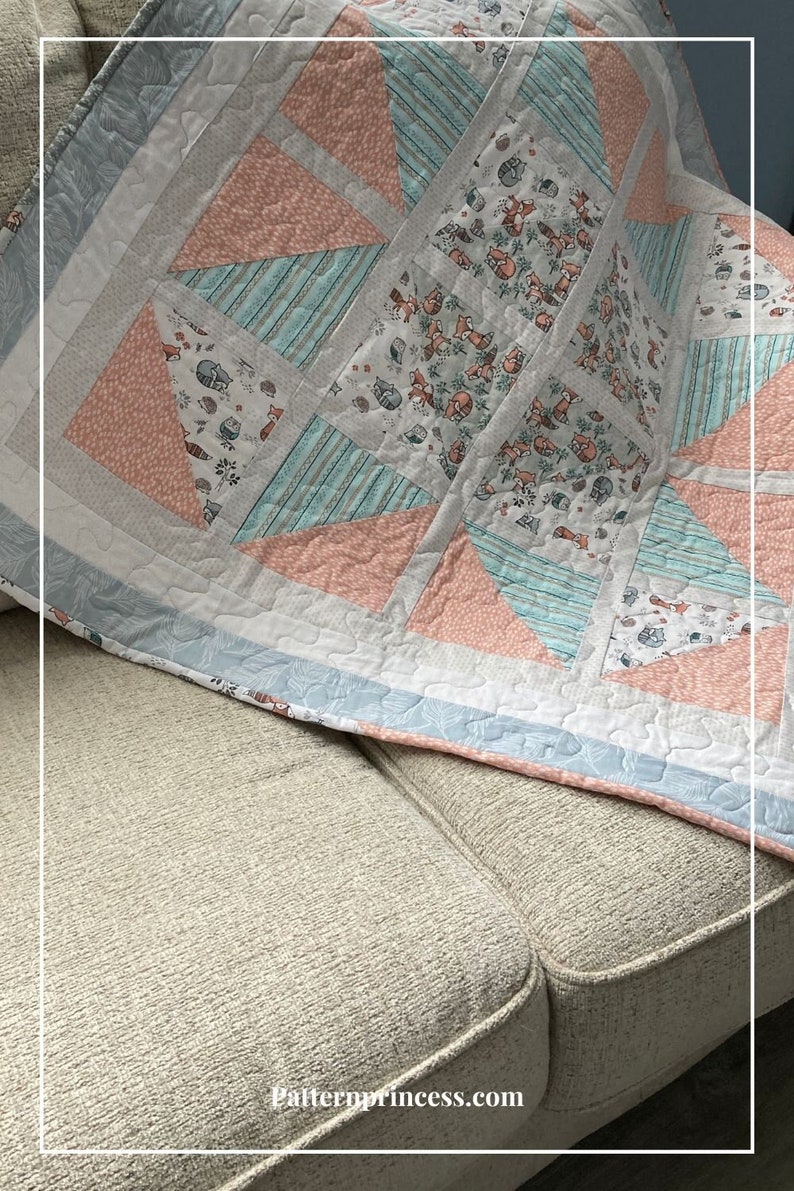 May include: A pink and blue baby quilt with a woodland animal print. The quilt is made of various fabrics and has a white border. The quilt is folded and placed on a light brown couch. The text 'Patternprincess.com' is visible at the bottom of the image. Quilting Pattern for Beginners, Farmhouse Quilt Pattern, Baby Quilts, Baby Quilt Pattern, Sweet Dreams Easy Quilt Pattern PDF