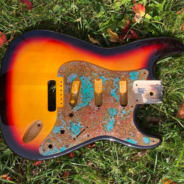 Sunburst Strat body with rusted patina steel pickguard. Modern USA specs. Neck Plate and screws. Just add neck and pickups. Ships Free.
