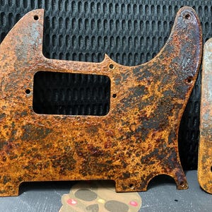 Rusted steel telecaster pickguard. Humbucker route. Includes control plate. Gloss finish.  ships free