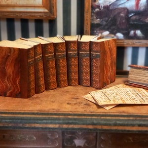 William Shakespeare replica set of 8 dolls house miniature books in 1:12 scale that open with blank  pages inside.