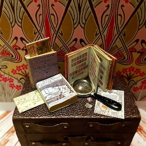 1:12 scale vintage worldwide stamp collectors set. This set  includes a useable magnifying glass.