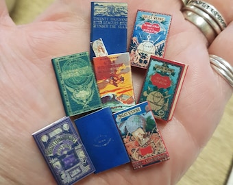 Jules Verne 1:12 scale dollhouse miniature vintage repli bookset.Each book has turnable aged blank pages. A loose bookmark is also included.