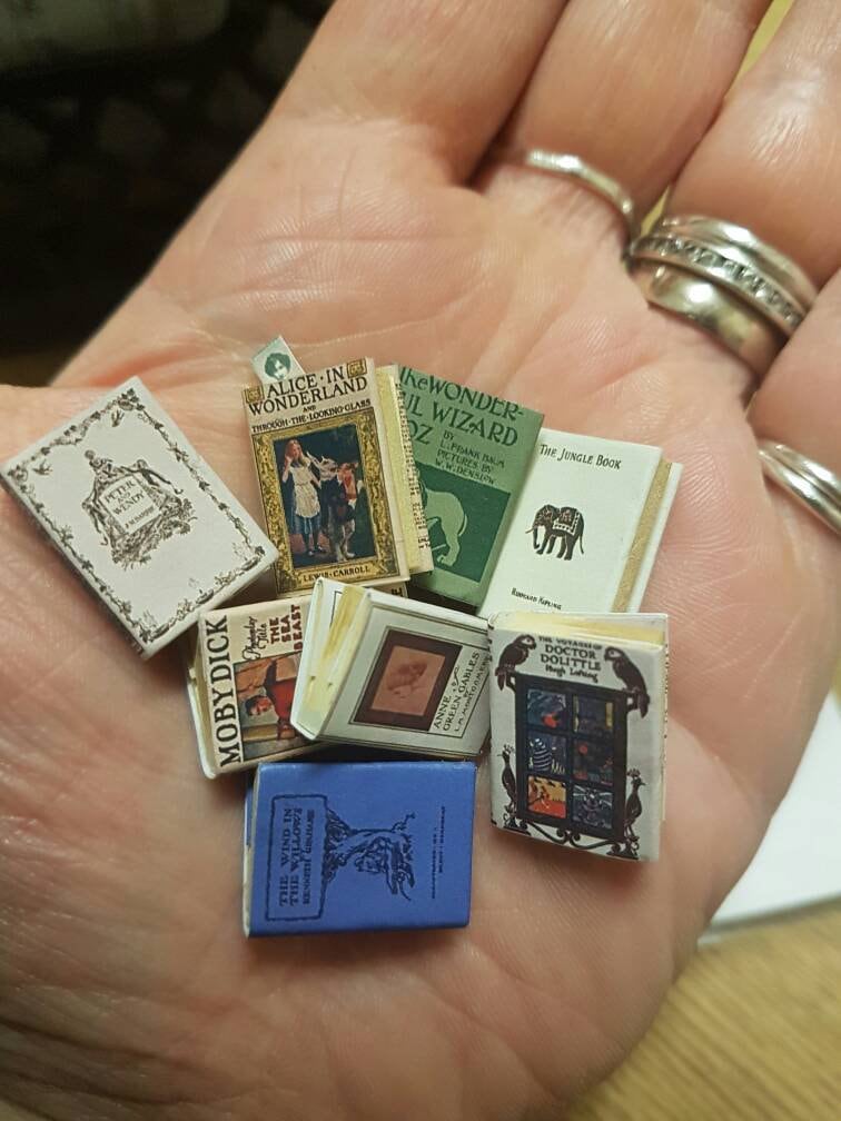 Miniature 1:12 scale children's dollhouse room  library set . Each book has aged turnable blank pages. A loose bookmark is also included.