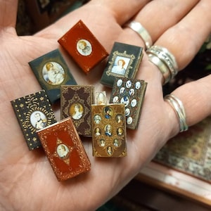 Set of 8 miniature antique 1.12 scale replica novels with blank turnable aged pages inside. A loose bookmark is also included.