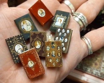 Set of 8 miniature antique 1.12 scale replica novels with blank turnable aged pages inside. A loose bookmark is also included.