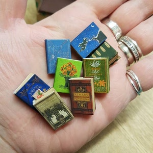 Antique replica set of 8 dolls house miniature books in 1:12 scale that open with blank  pages inside.