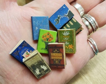 Antique replica set of 8 dolls house miniature books in 1:12 scale that open with blank  pages inside.