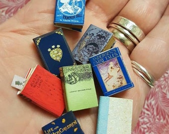 Antique replica set of 8 dolls house miniature books in 1:12 scale that open with blank  pages inside.