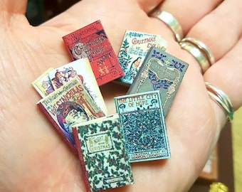 May include: A collection of miniature vintage Christmas books with titles like "The Wonderful Christmas Tree", "Robin's Christmas Eve", "The Night Before Christmas or A Visit From St. Nicholas", "The Little City of Hope", and "A Night Before Christmas".