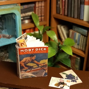 Libro vintage in miniatura di casa delle bambole in scala 1:12 di Moby Dick. Sono inclusi anche un segnalibro sciolto e delle cartoline.