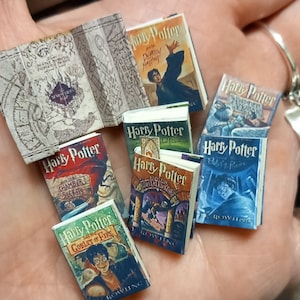 May include: Miniature Harry Potter book replicas, including "Harry Potter and the Sorcerer's Stone," "Chamber of Secrets," and "Goblet of Fire." The books feature colorful covers and detailed illustrations, perfect for collectors.