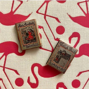 Alice in Wonderland 1:12 scale dollhouse miniature  replica twin set.Each book has  aged blank pages. A  loose bookmark is also included.