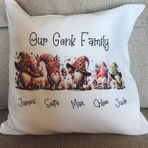 May include: White cushion featuring a colourful gnome family illustration and the text "Our Gonk Family". Beneath the gnomes are the names James, Sofia, Max, Chloe, and Jude.