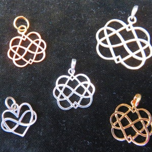 May include: Five silver and gold infinity heart charm pendants. The charms are in various sizes and feature a Celtic knot design.