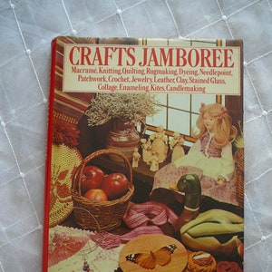 May include: A book titled "Crafts Jamboree" with a red cover and a colorful illustration of various crafts, including a wooden butterfly, a woven basket with apples, a doll, and a duck.