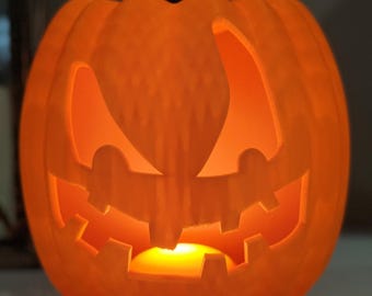 May include: A carved orange pumpkin with a spooky face, illuminated from inside. The pumpkin features triangular eyes, a zig-zag mouth, and a dark brown stem. The interior glows warmly, suggesting a candle or light source, perfect for Halloween.