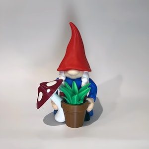 May include: A whimsical garden gnome figurine. The gnome wears a tall red hat and a blue tunic. It holds a brown pot with green plants and a red and white mushroom. The figurine is a charming addition to any garden or home decor.