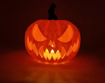May include: An illuminated orange Halloween pumpkin with a carved face, featuring triangular eyes and a jagged mouth. The pumpkin has a black stem and is lit from within, creating a warm glow.