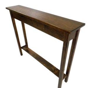May include: A dark brown wooden console table with a shelf. The table has a simple design with straight legs and a rectangular top.
