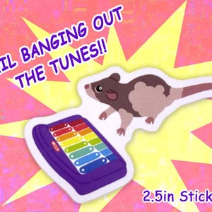 May include: A sticker featuring a cartoon rat and a xylophone with rainbow-colored keys. The sticker also includes the text "NEIL BANGING OUT THE TUNES!!" and "2.5in Sticker". The background is pink and yellow.