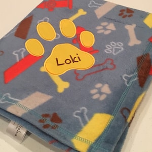 Dog Blanket with embroidered paw print.