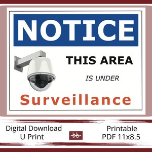 May include: A red and white sign with the word "NOTICE" in blue letters. The sign says "This area is under surveillance" and has a picture of a security camera. The sign also says "Digital Download U Print" and "Printable PDF 11x8.5".