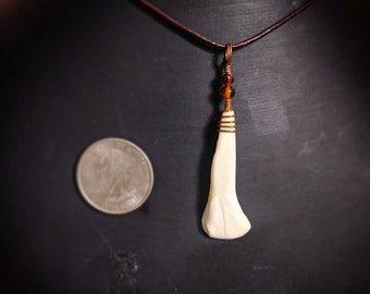 Tooth pendant. Bone necklace. Ethically sourced. Amber jewelry. Garnet beads. Under 25 dollars. Festival apparel. All natural.