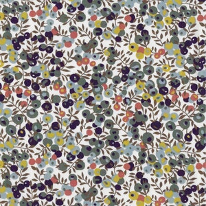 Puede incluir: Una tela blanca con un patr&oacute;n repetitivo de peque&ntilde;os puntos coloridos y ramas marrones. Los puntos son en tonos de azul, verde, amarillo y rojo.