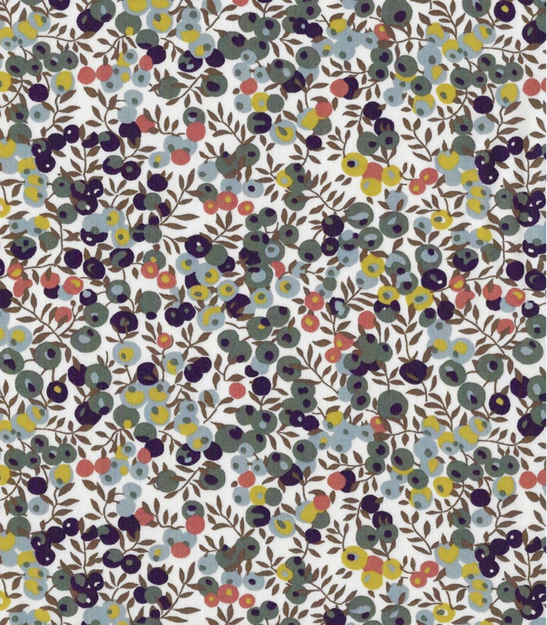 Puede incluir: Una tela blanca con un patr&oacute;n repetitivo de peque&ntilde;os puntos coloridos y ramas marrones. Los puntos son en tonos de azul, verde, amarillo y rojo.