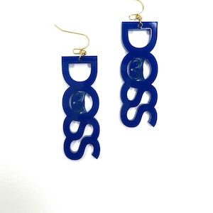 May include: A pair of blue acrylic earrings shaped like the word "BOSS".