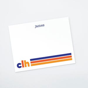 May include: White stationery card with blue and orange stripes at the bottom. The text "james" is printed in blue at the top of the card. The letters "clh" are printed in blue with a blue circle around the "c" and a blue line connecting the "c" to the "h".