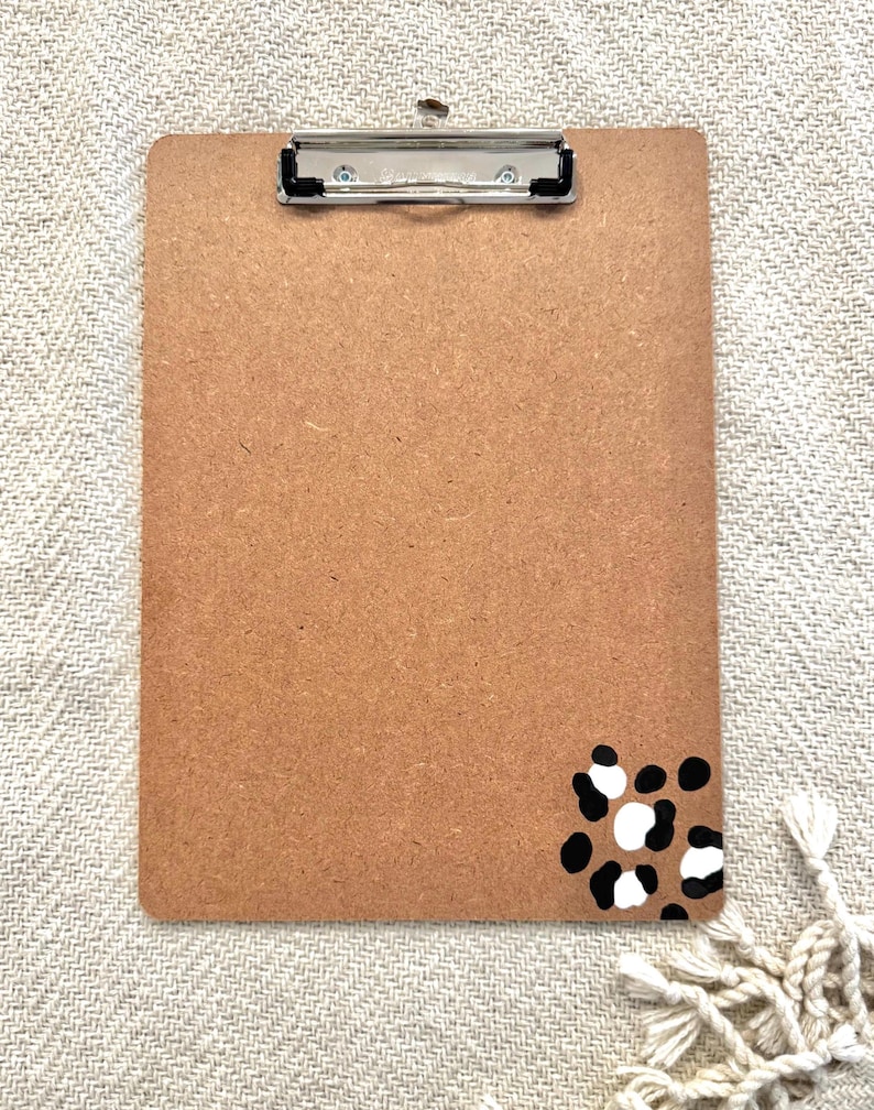 May include: A brown clipboard with a black and white leopard print design in the bottom right corner.