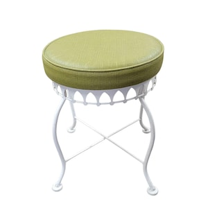 May include: A round stool featuring a textured light green upholstered seat cushion. The base is constructed from white metal with four curved legs, a decorative scalloped apron detail, and a cross-brace support structure connecting the legs.