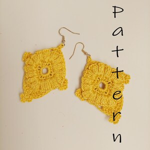 May include: A pair of bright yellow crochet earrings featuring a square motif with a central open circle and textured stitching. The earrings hang from gold-toned metal hooks. The word Pattern is written vertically in black text on the right side.