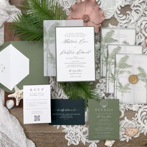 May include: An assortment of wedding stationery, including invitations, RSVP cards, and details cards, in shades of green and white. The invitations feature palm tree designs and elegant calligraphy. Decorative elements include seashells, a pink flower, and a wax seal.