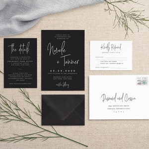May include: Black and white wedding invitation suite with calligraphy font. The invitation card features the names "Norveke + Tanner" and the date "05.23.2020". The RSVP card has the text "Kindly Respond" and a space for guests to indicate their attendance.