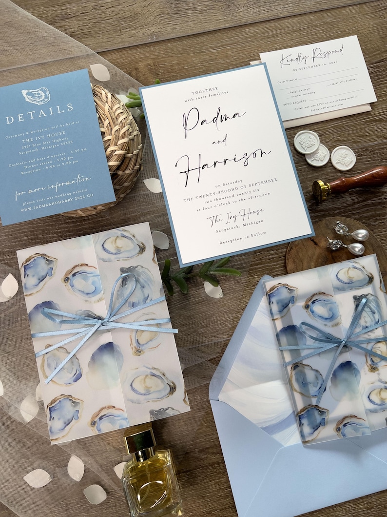 Coastal Oyster Wedding Invitation Suite with vellum jacket, envelope liner, and blue ribbon