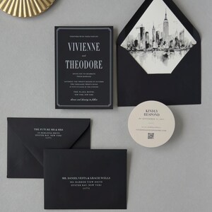 Elegant black wedding invitation and envelope with black-and-white city skyline liner, paired with taupe and ivory coordinating stationery.