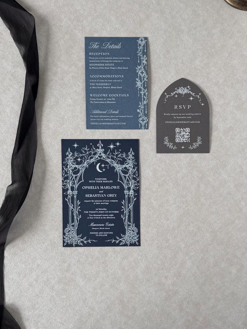 Ophelia celestial wedding stationery featuring a midnight navy invitation with ornate white ink archway, coordinating Marina details card, and Dark Grey tombstone-shaped RSVP website card with QR code.