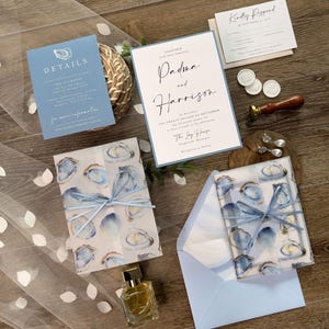 Oyster Clamshell Wedding Invitation Suite with printed vellum jacket and envelope liner