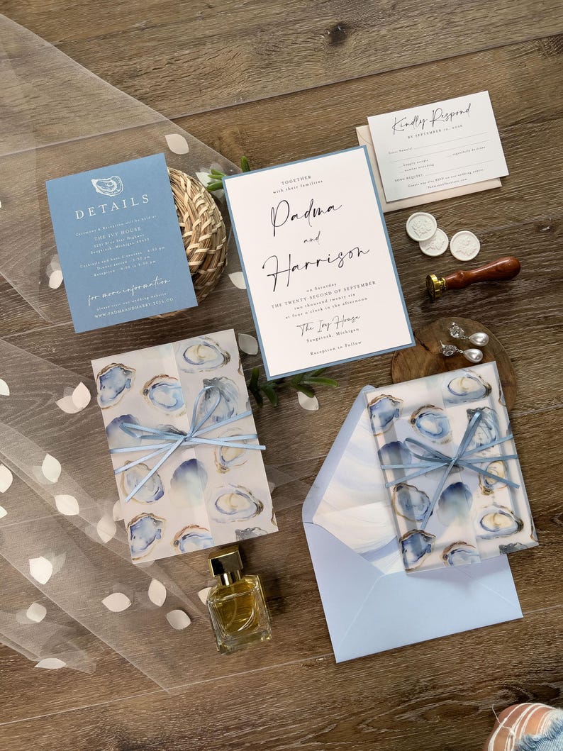 Oyster Clamshell Wedding Invitation Suite with printed vellum jacket and envelope liner