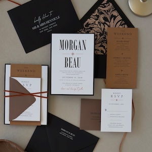 Complete Whitmore wedding invitation suite featuring black, white and warm brown stationery, layered invitation, RSVP card and thin copper-toned ribbon for a modern wedding.