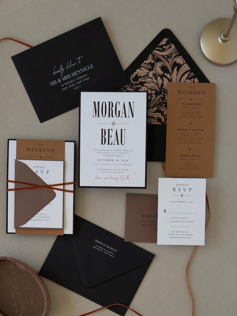 Complete Whitmore wedding invitation suite featuring black, white and warm brown stationery, layered invitation, RSVP card and thin copper-toned ribbon for a modern wedding.