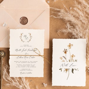 May include: Wedding invitation suite with a rustic, floral theme. The invitation features a wreath with the initials "M&E" and the text "Together with their families" above the names "Mello Jade Farraday & Ethan Kane Castro". The RSVP card features a watercolor illustration of dried flowers with the text "With Love".