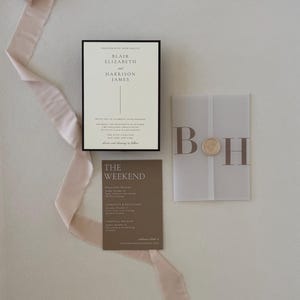 Close-up of the ivory Blair wedding invitation featuring a thin chocolate brown border and elegant minimalist typography for a timeless neutral wedding.