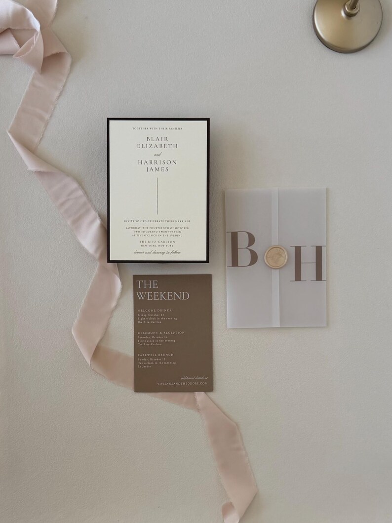 Close-up of the ivory Blair wedding invitation featuring a thin chocolate brown border and elegant minimalist typography for a timeless neutral wedding.