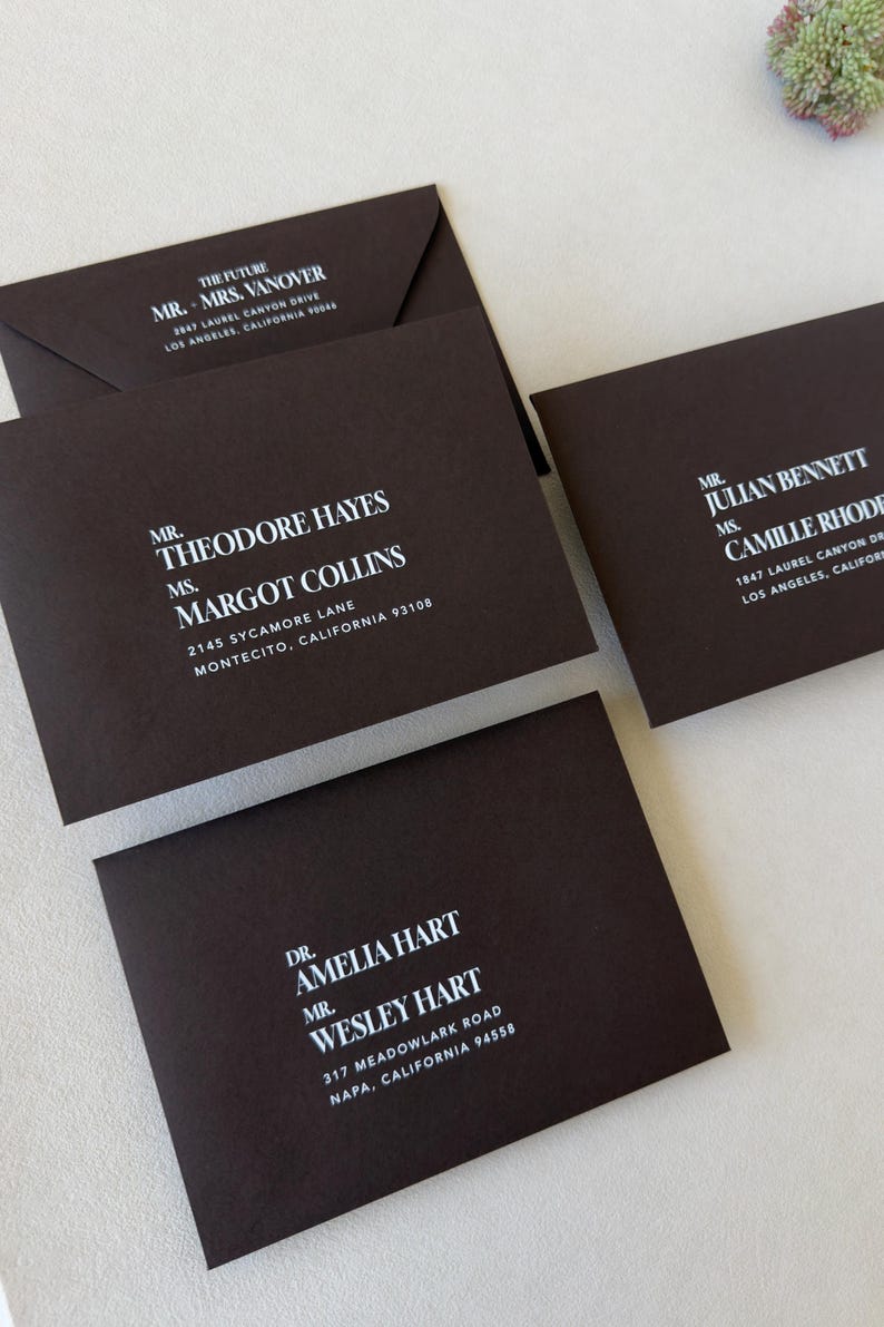 Dark brown wedding envelope with bold abstract liner with white ink addresses printed on the front