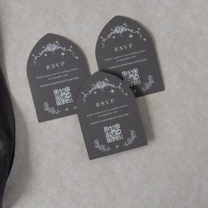 Three Dark Grey tombstone-shaped wedding RSVP cards arranged on a neutral textured background, featuring delicate white decorative artwork and QR codes for online guest responses.