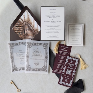 Dark academia wedding stationery displayed with a white invitation featuring elegant typography, antique architectural artwork, vintage-style decorative cards, burgundy bookmark, and dark envelope with an ornate staircase liner.