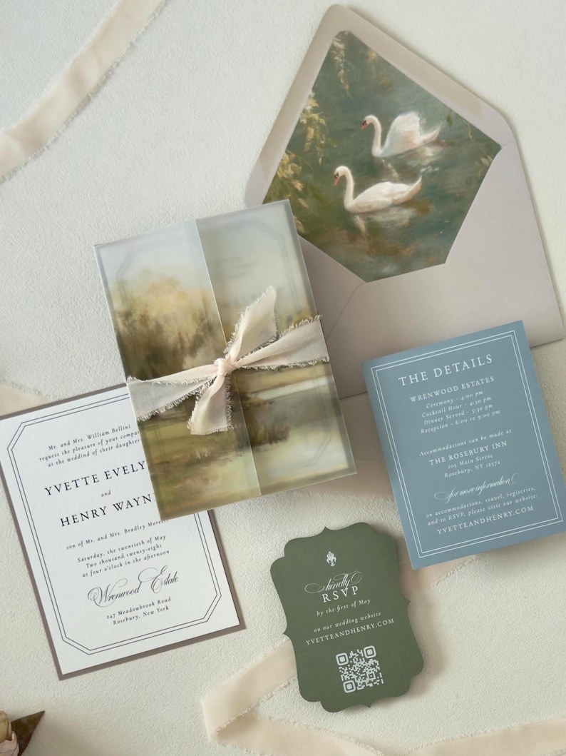 Elegant country wedding invitation suite featuring an ivory invitation, dusty blue details card, scalloped green RSVP card, scenic landscape vellum wrap and romantic swan envelope liner.